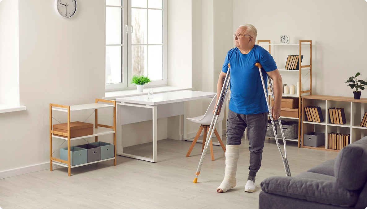 Man on crutches at home walking