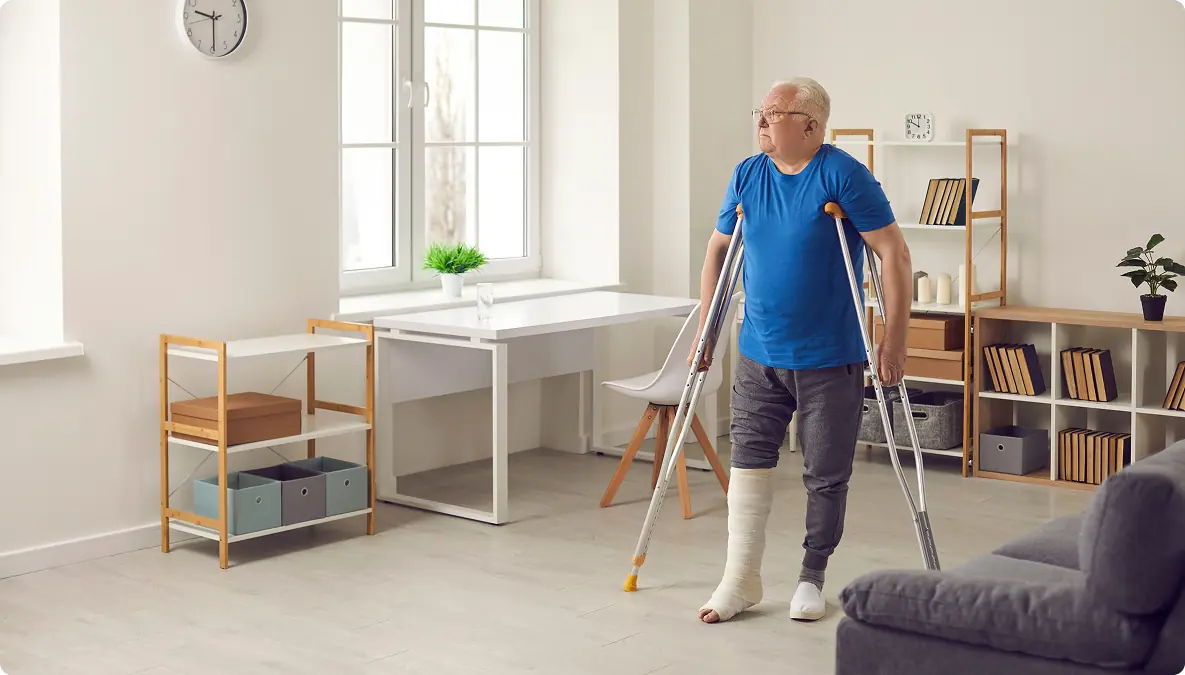 Man on crutches at home walking