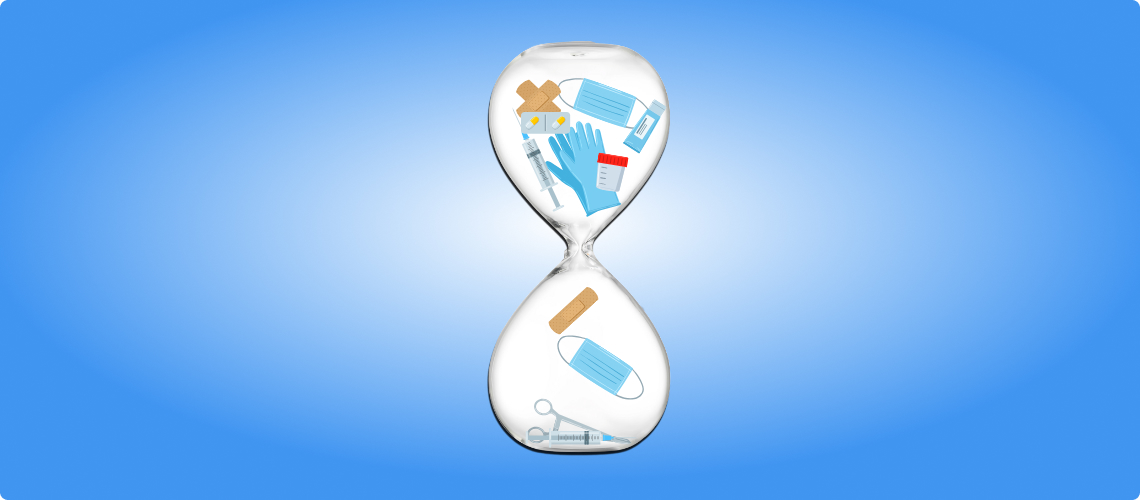 Hourglass filled with hospital medical supplies, masks, syringes